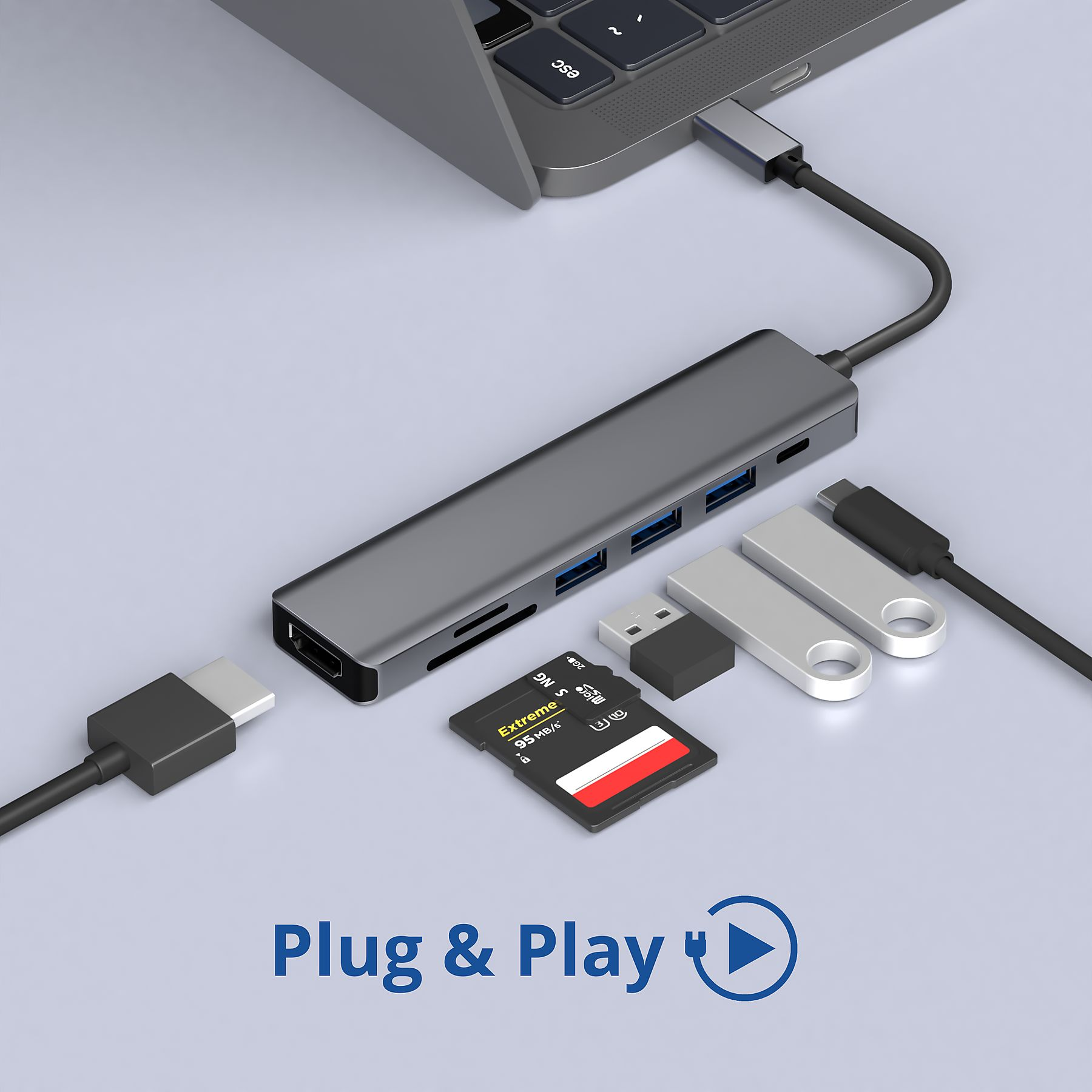 Silberner USB-Hub, an einen Laptop angeschlossen. Inkl. USB-Laufwerke, SD-Karte und Adapter.