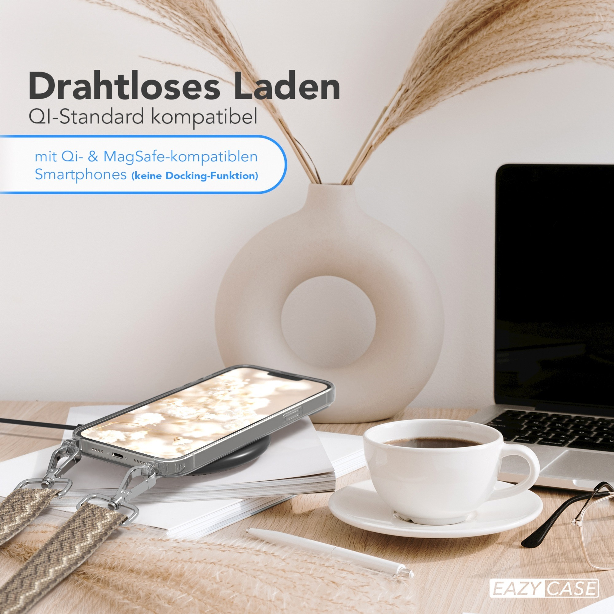 Ein Telefon, das drahtlos auf einem Schreibtisch geladen wird, mit einer Tasse Kaffee und einem Laptop im Hintergrund.