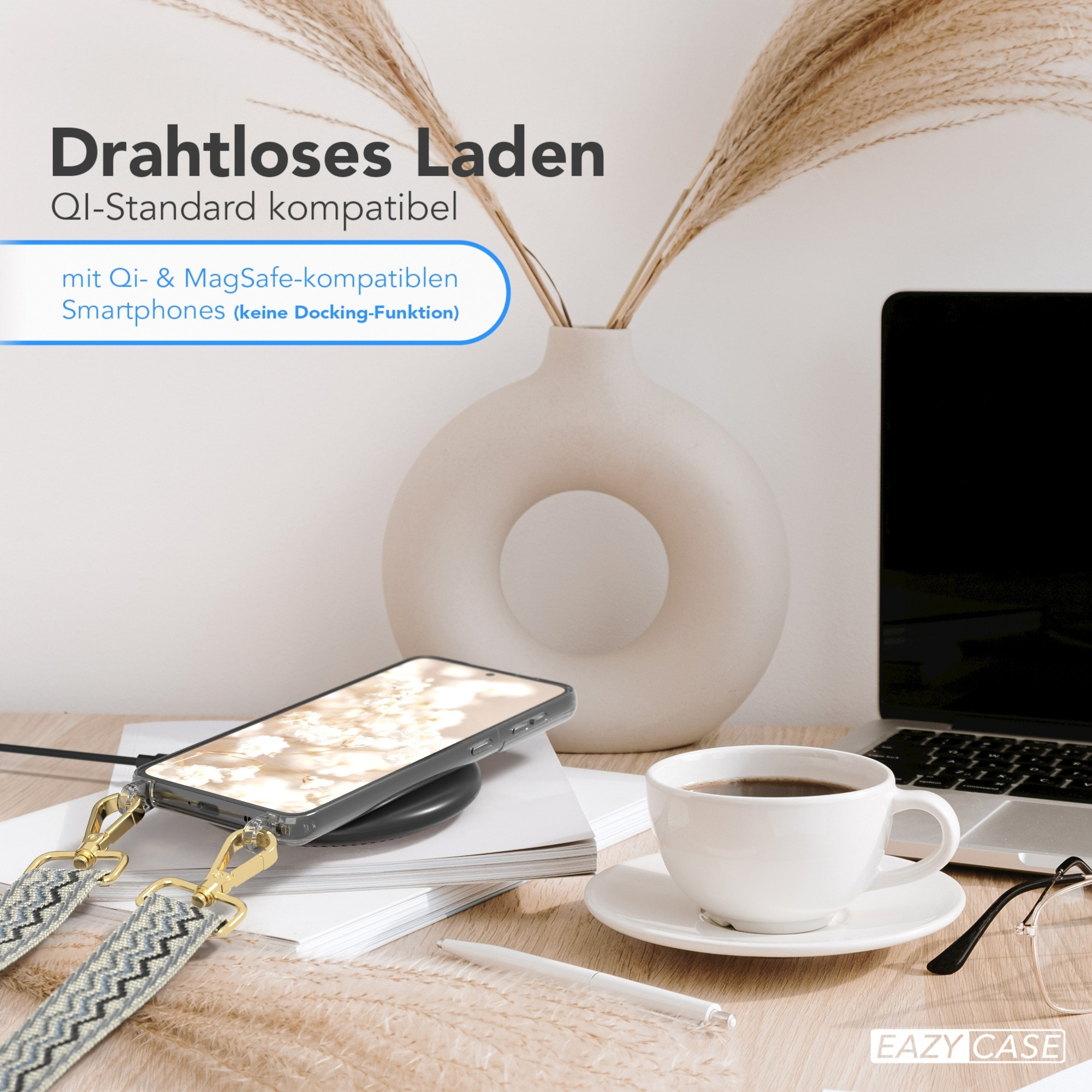 Telefon auf kabellosem Ladegerät. Kaffeetasse, Stift und Laptop auf einem Holztisch.