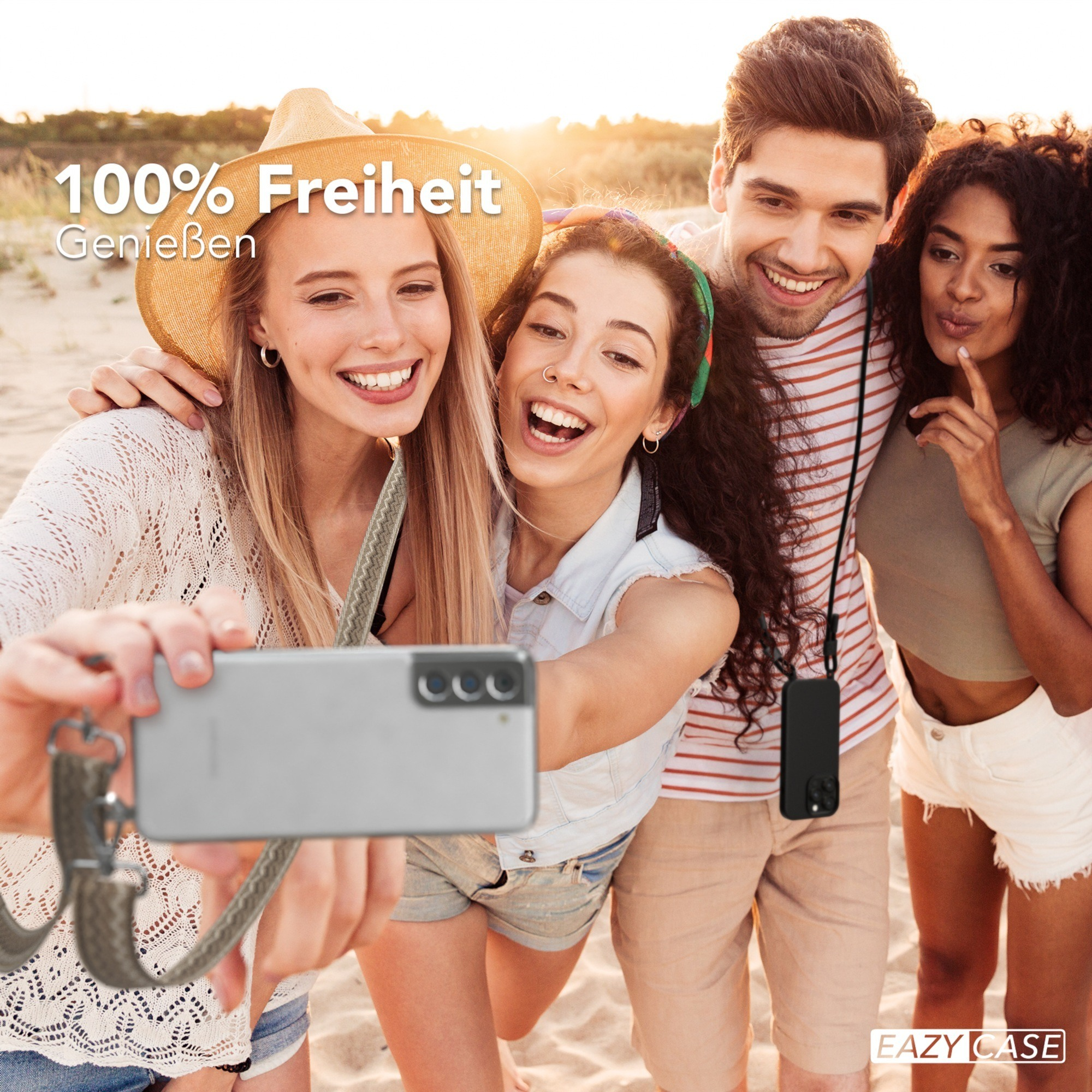 Vier Personen machen ein Selfie am Strand mit einem Telefon. Die Worte sind 100% Freiheit.