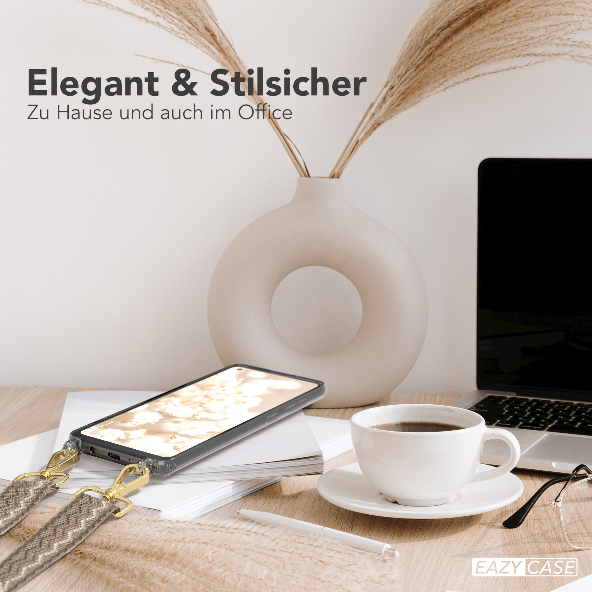 Telefon auf einem Schreibtisch mit Band, eine Tasse Kaffee und eine Vase mit Pflanzen.