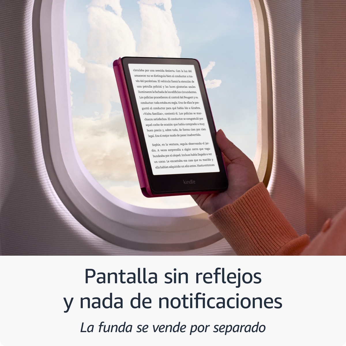 Kindle E-Reader mit Text, gehalten von einer Hand in der Nähe eines Fensters. Der E-Reader ist rot.