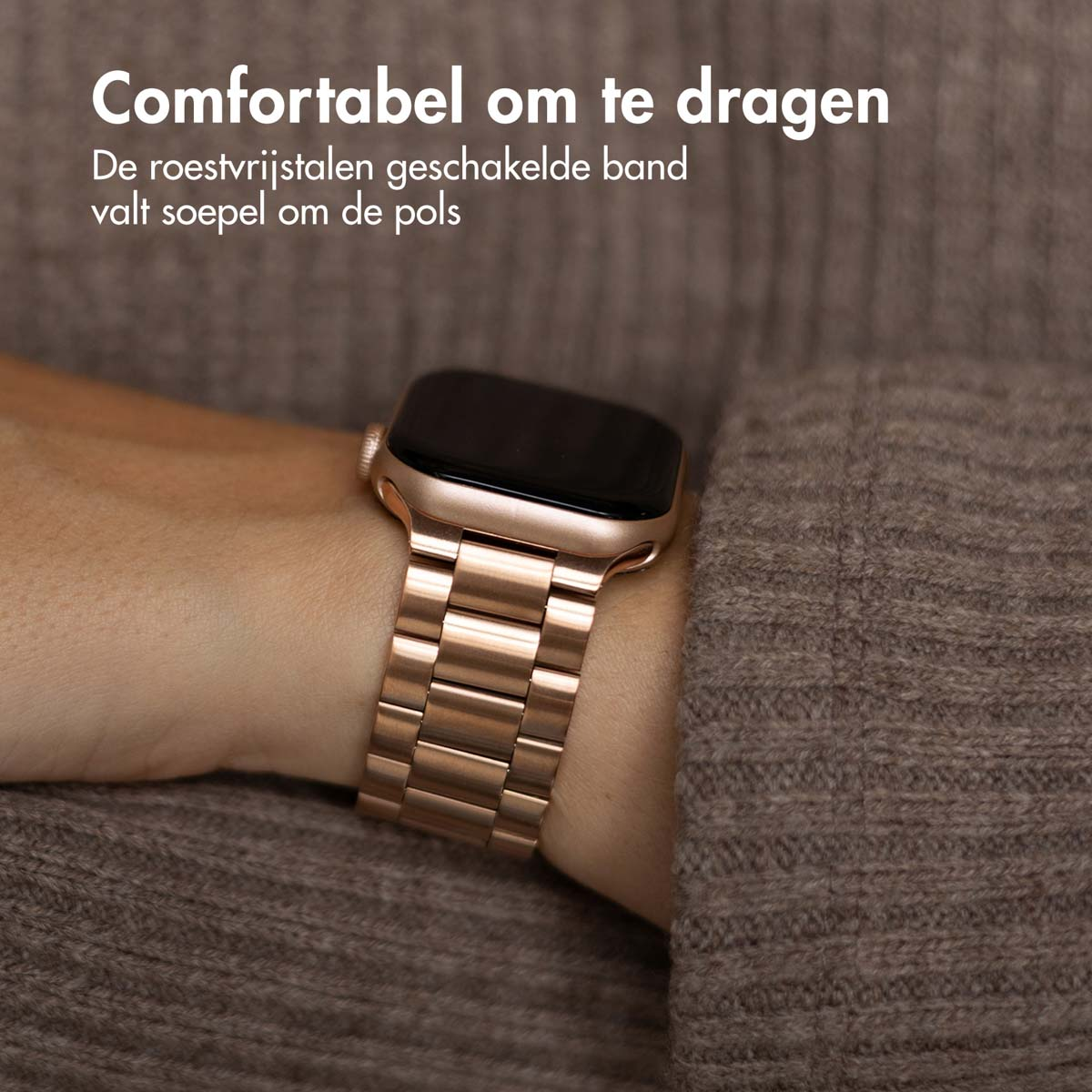 Wrist with a rose gold watch. Watch has a metal band.