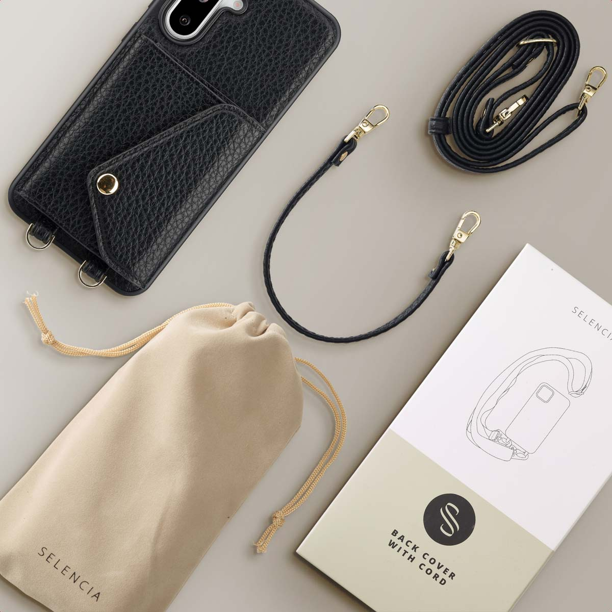 Zwarte telefoonhoes met een riem, etui en een doos met een telefoonillustratie.