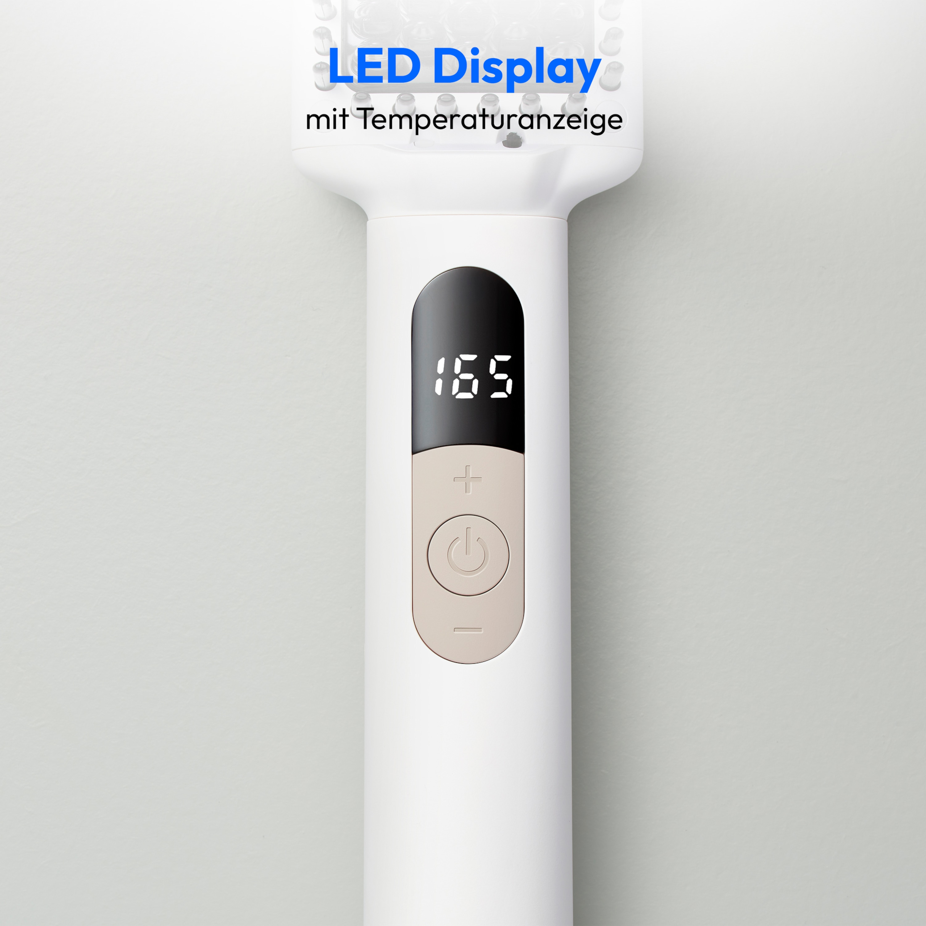 Un'attrezzo bianco per lo styling dei capelli con un display digitale che mostra una temperatura di 165 gradi Celsius.