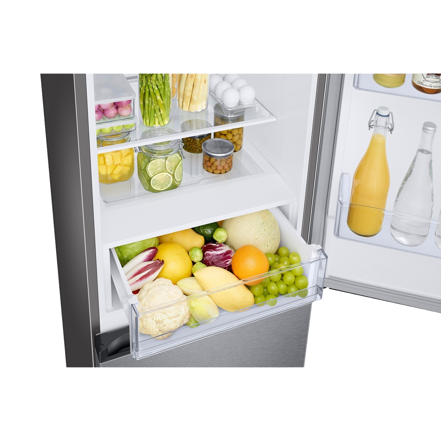 Refrigerator interior with shelves of fruits and vegetables in drawers. Stainless steel.