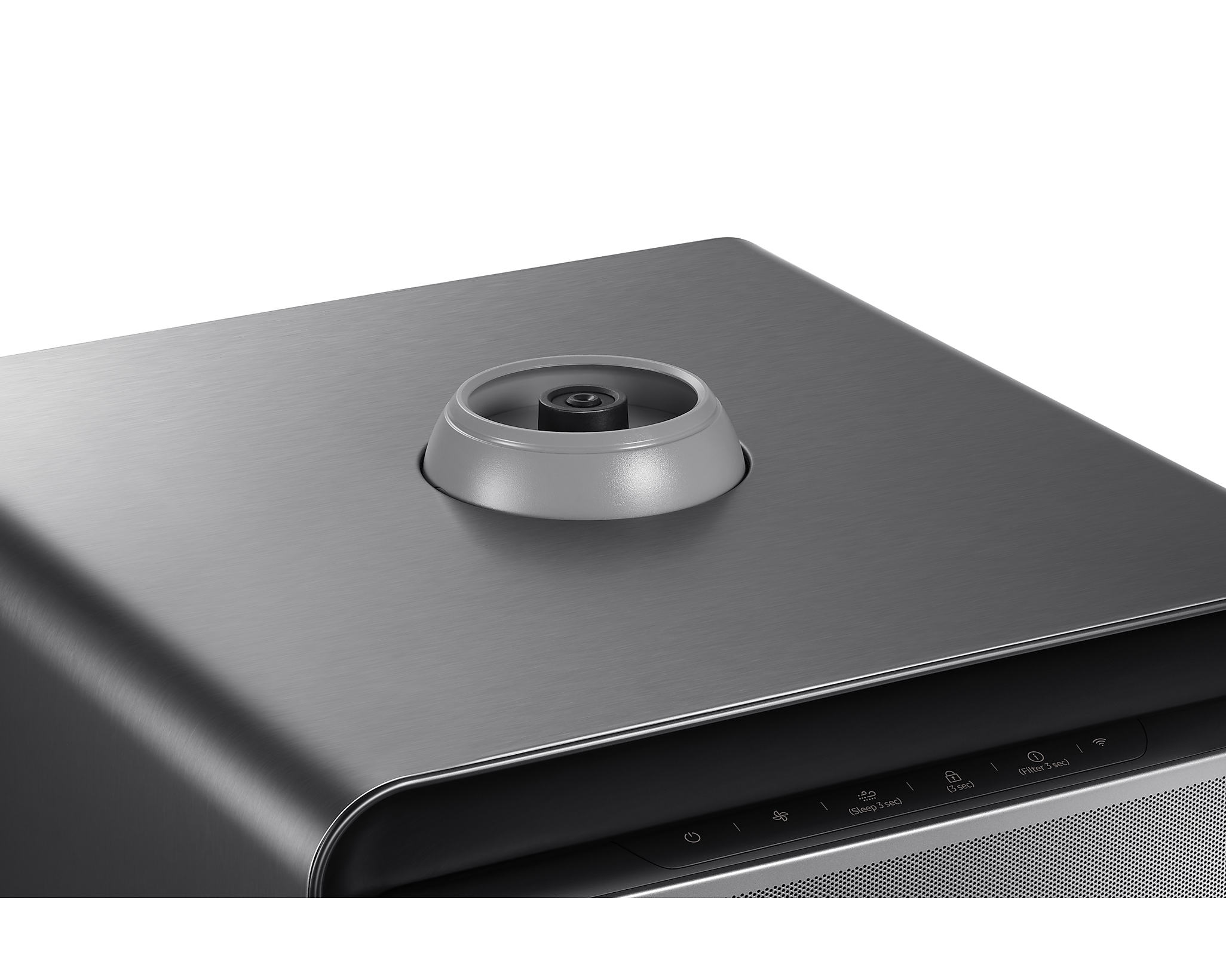 Widok z góry na ciemne metalowe urządzenie ze srebrnym okrągłym elementem.