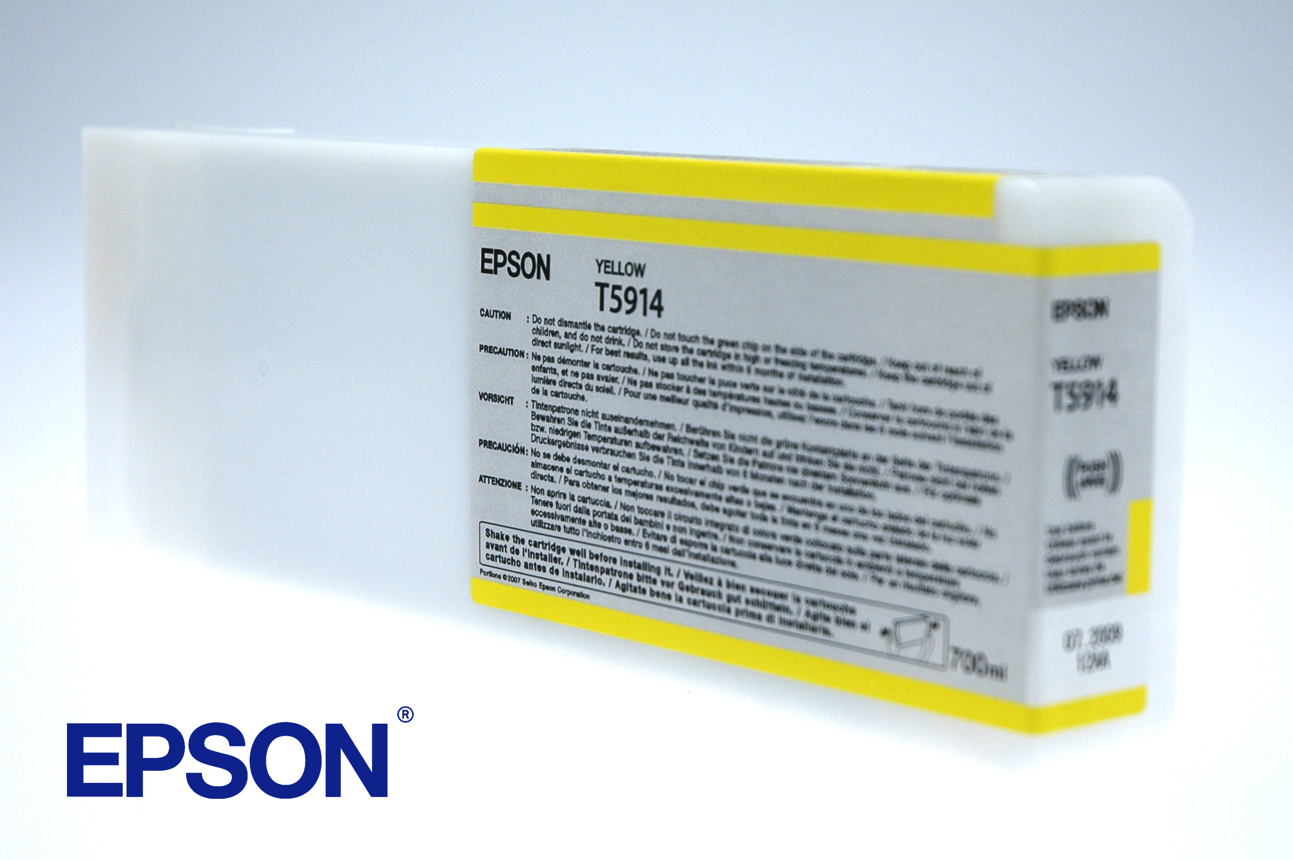 Cartucho de tinta Epson amarillo, texto amarillo, fondo blanco. Etiquetas de precaución visibles.