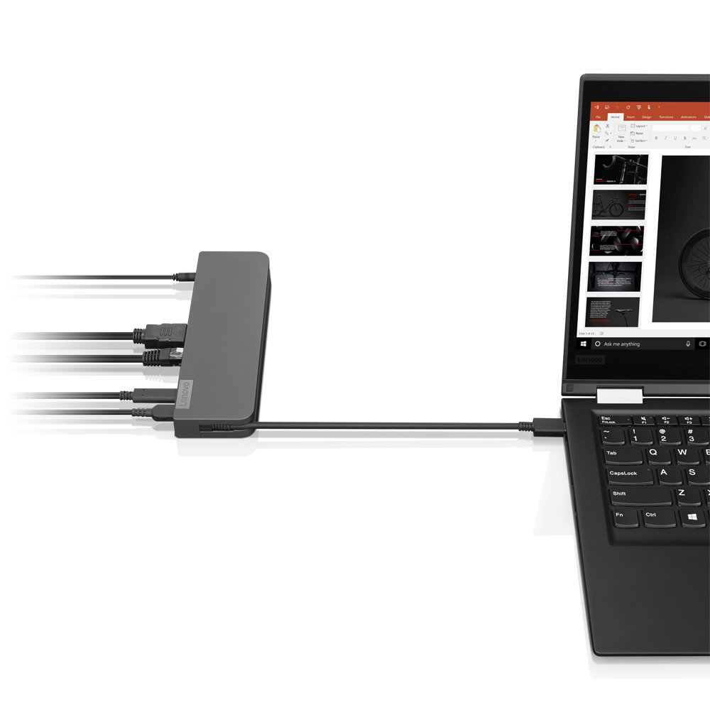 Laptop, der mit einer grauen Lenovo Dockingstation verbunden ist. Laptop zeigt eine Präsentation.