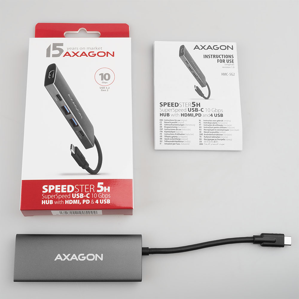 Scatola, hub e manuale Axagon Speedster 5H. Testo sulla scatola: Superspeed USB-C 10 Gbps Hub con HDMI, PD e 4 USB.