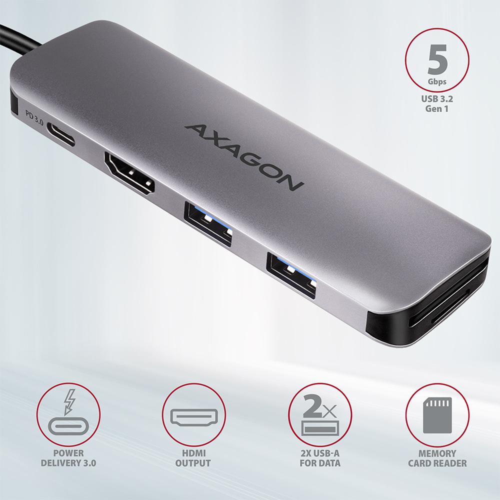Hub argentato con più porte: PD, HDMI, USB e lettore di schede SD. Sfondo nero.