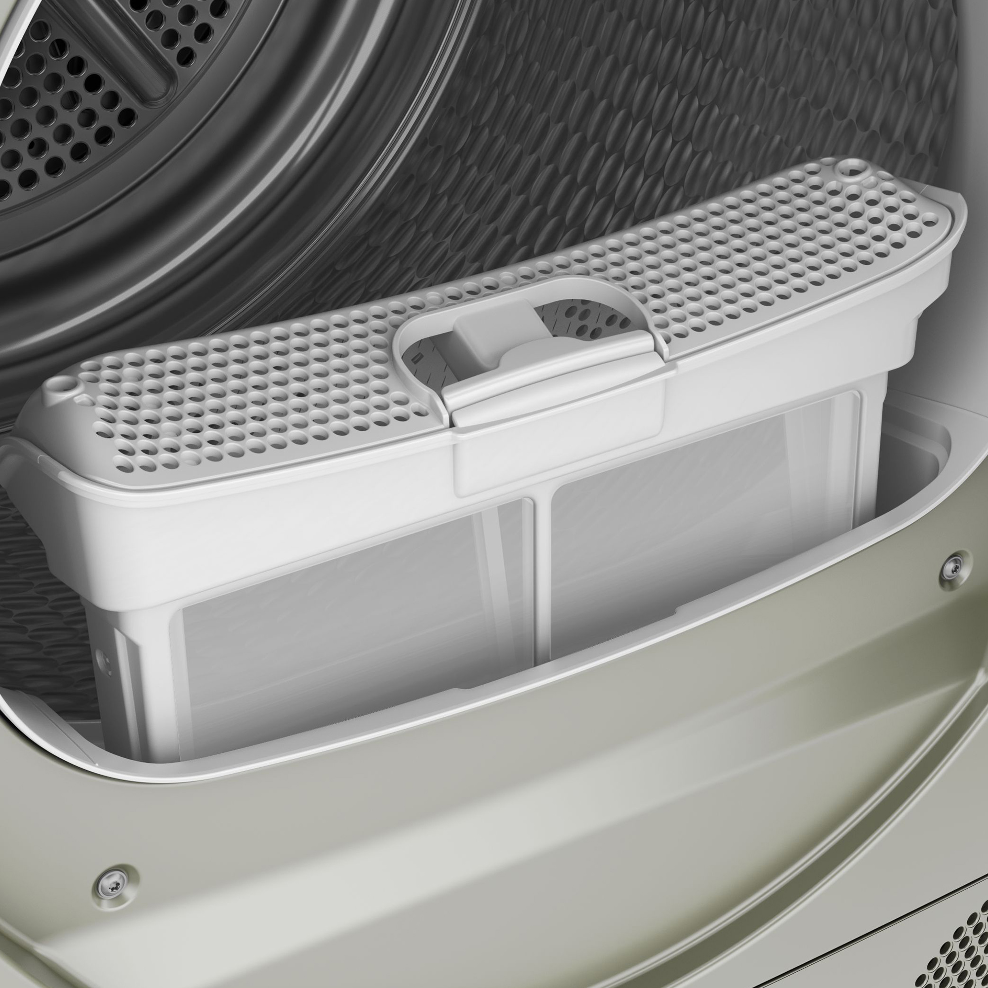 Un primo piano del vano filtro bianco dell'asciugatrice all'interno di un'asciugatrice.