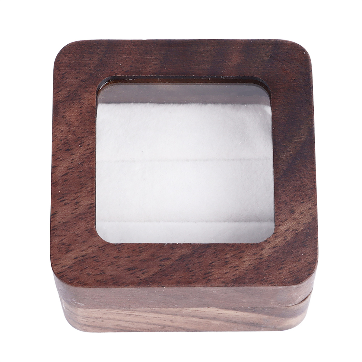 Eine Holzkiste mit durchsichtigem Deckel und einem weißen Kissen im Inneren.