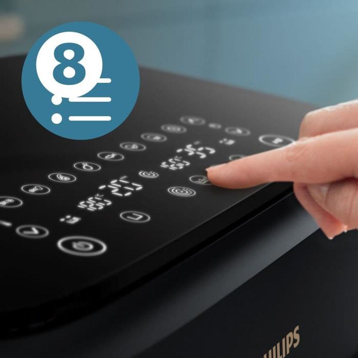 Czarne urządzenie z ręką naciskającą przycisk. Jest na nim kilka przycisków.