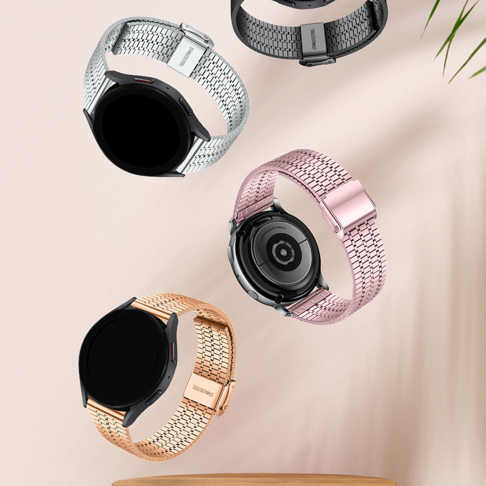 Vier Smartwatches. Silberne, schwarze, roségoldene und goldene Armbänder. Die Uhren haben schwarze Displays.