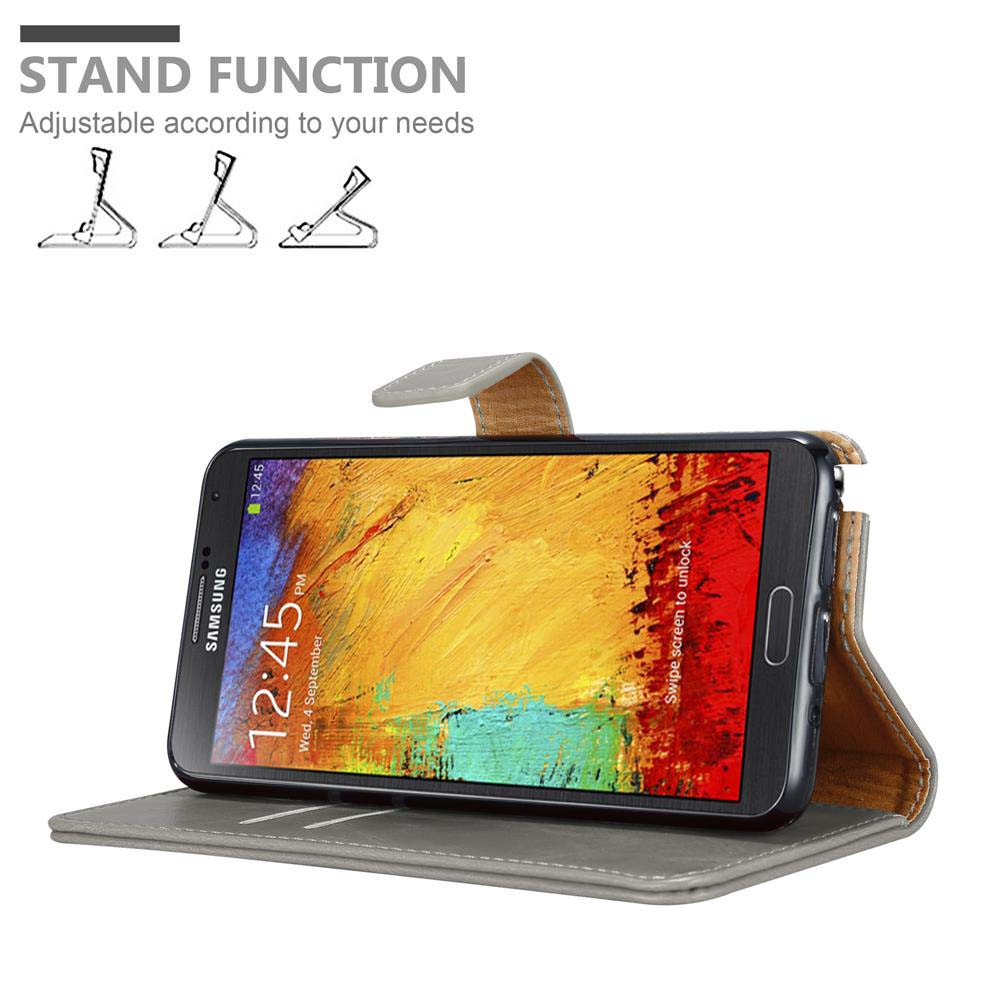 Un teléfono en una funda, en posición de pie. La pantalla del teléfono muestra una pintura colorida.