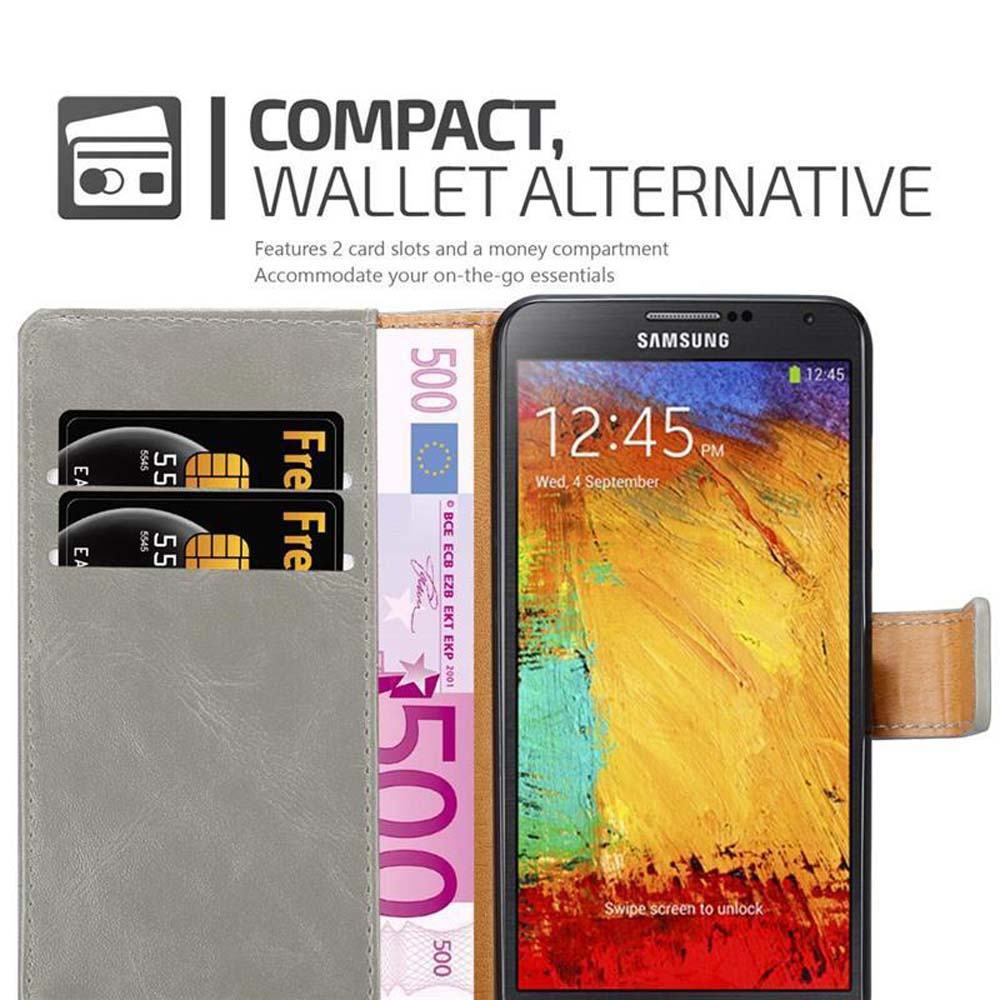 Un smartphone en una funda tipo cartera, con dos tarjetas y algo de efectivo visibles.