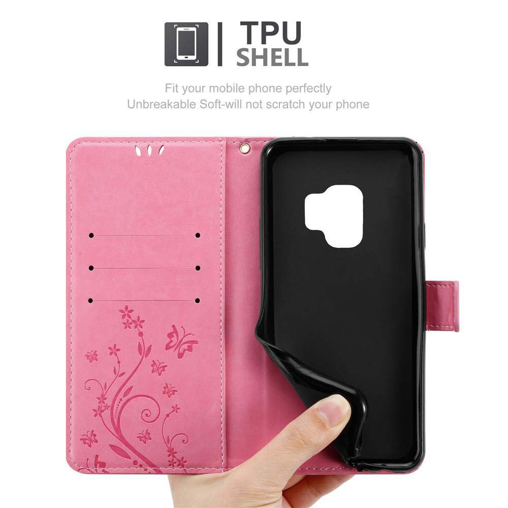 Custodia rosa per telefono con custodia interna nera. Ha un design floreale e una mano che la apre.