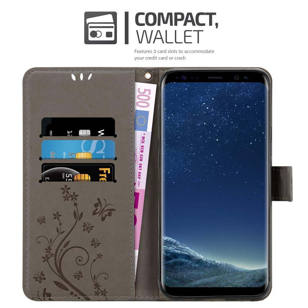 Custodia per telefono con design a portafoglio. Ha slot per carte e un telefono con cielo stellato.