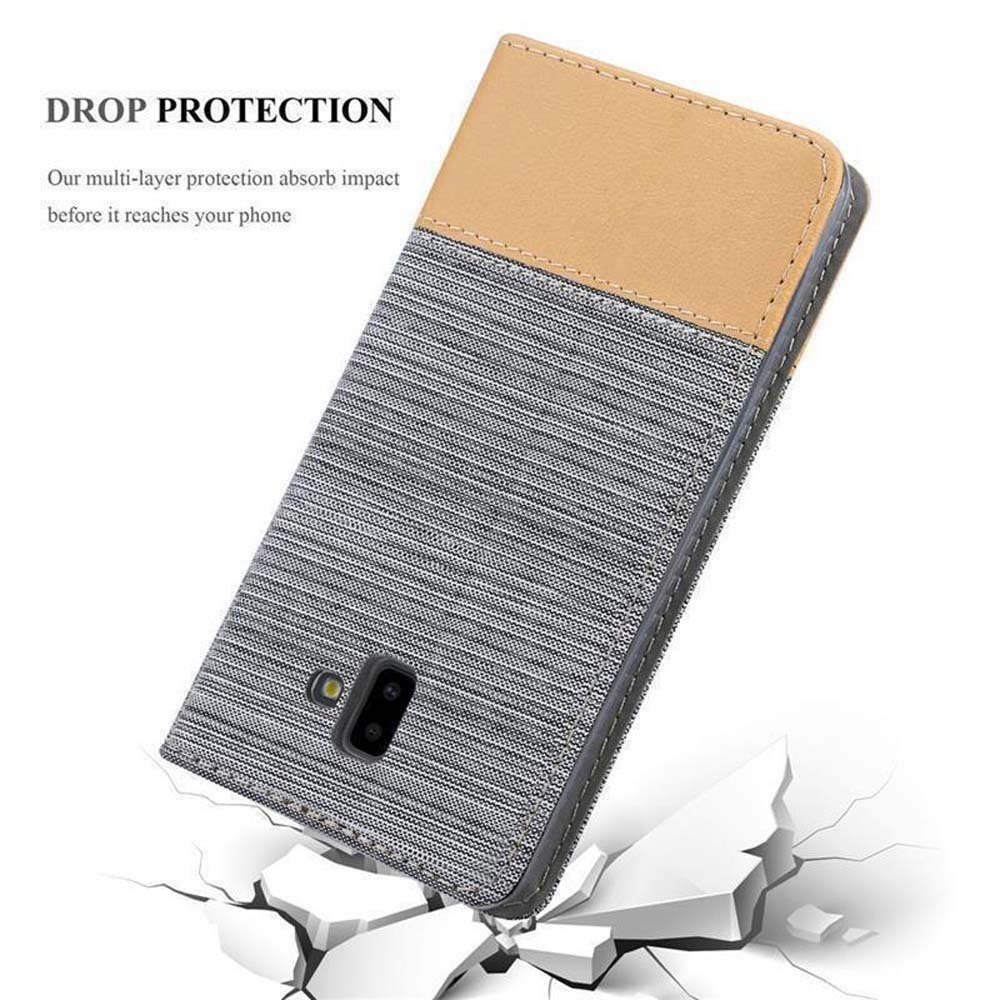 Handyhülle mit grau gestreiftem Stoff und beigem Oberteil, auf zerbrochenem Stein. Drop Protection Label.