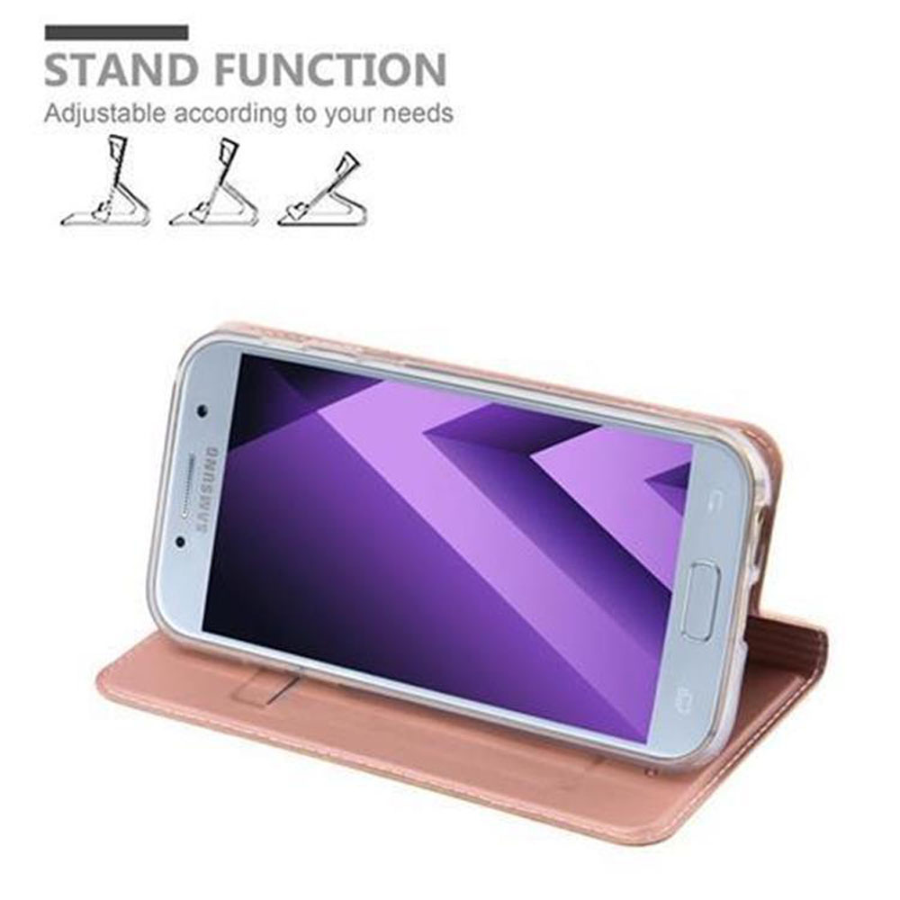 Telefon in einer pinken Hülle, geöffnet, um den Bildschirm zu zeigen. Hülle auf einem Tisch. Text sagt 'Standfunktion'. Weißer Hintergrund.
