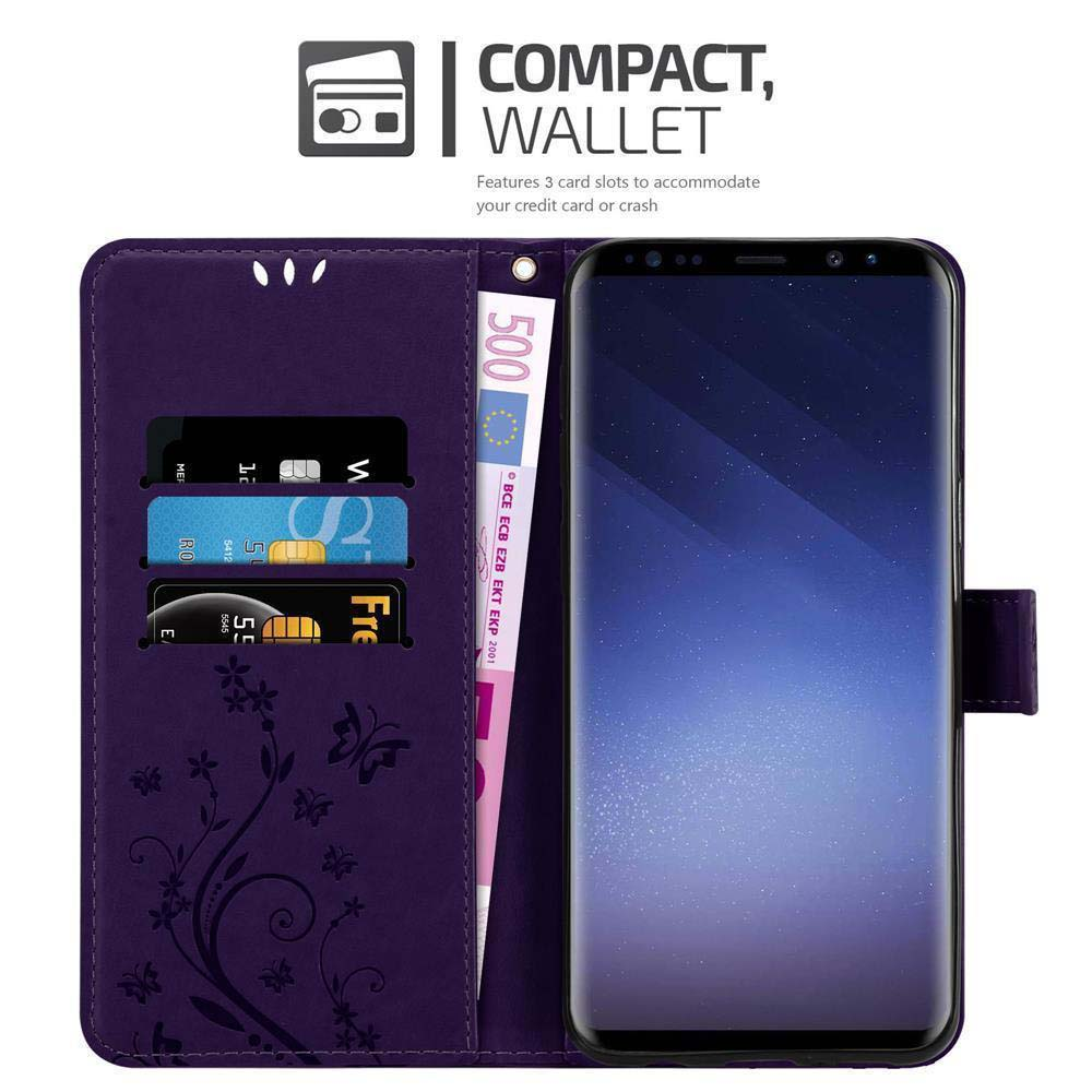 Custodia per telefono viola aperta con carte e denaro. Il telefono nero è visibile. Design floreale.