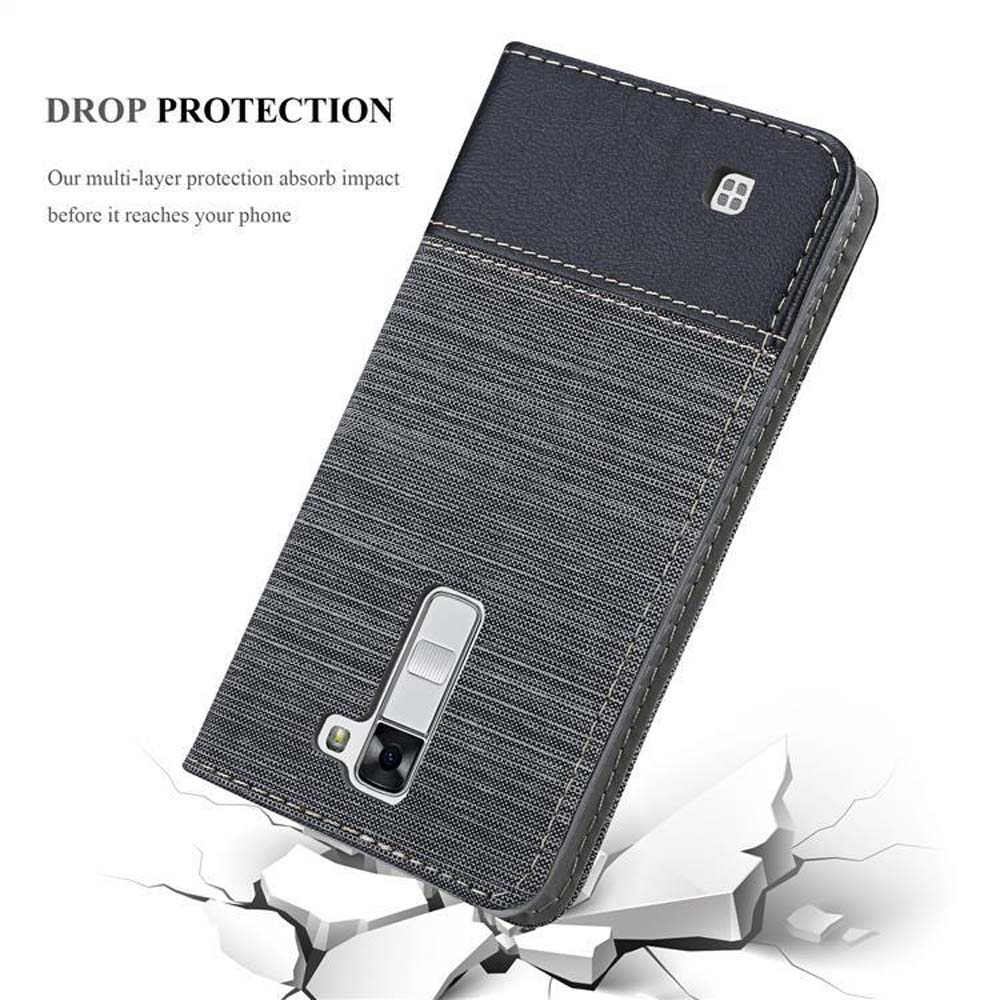 Funda de teléfono negra y gris, texto Drop Protection y gráfico de impacto, sobre fondo blanco.