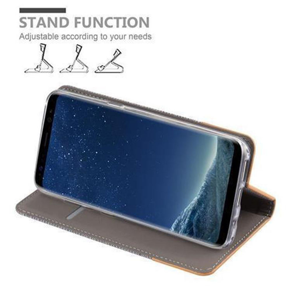 Ein Telefon in einem grauen Gehäuse ist aufgestellt. Text: STANDFUNKTION.