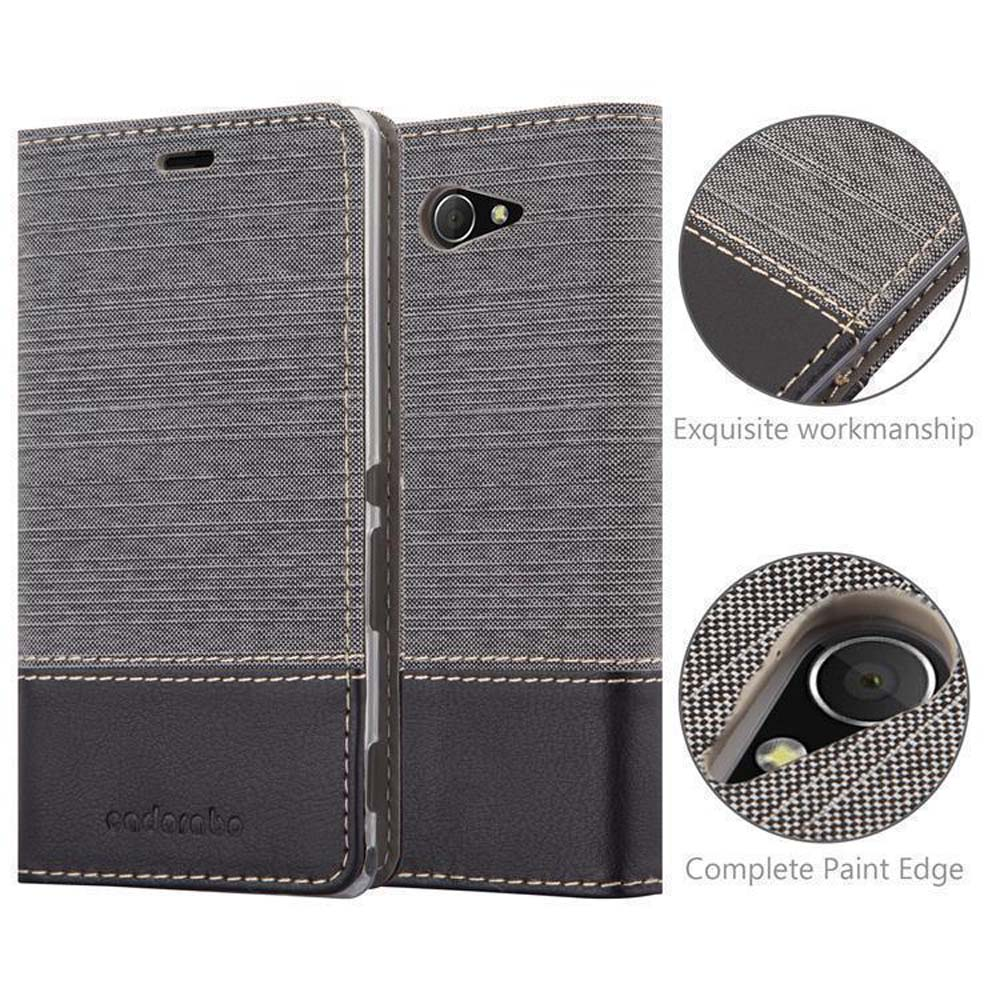Una funda de teléfono gris con una sección negra. La funda está cerrada. El fondo es blanco.