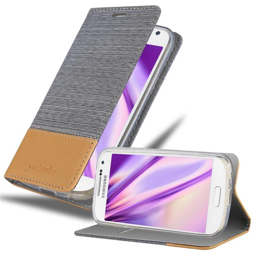 Teléfono blanco en una funda, abierto. Estuche gris con acento marrón en el fondo.