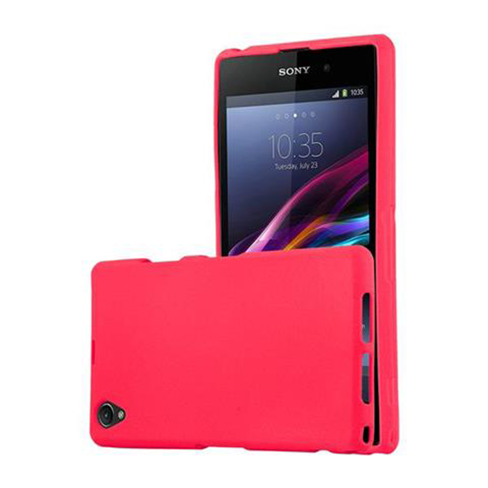 Un teléfono rojo brillante con una funda. La pantalla muestra la hora y la fecha. Otra funda roja al lado.