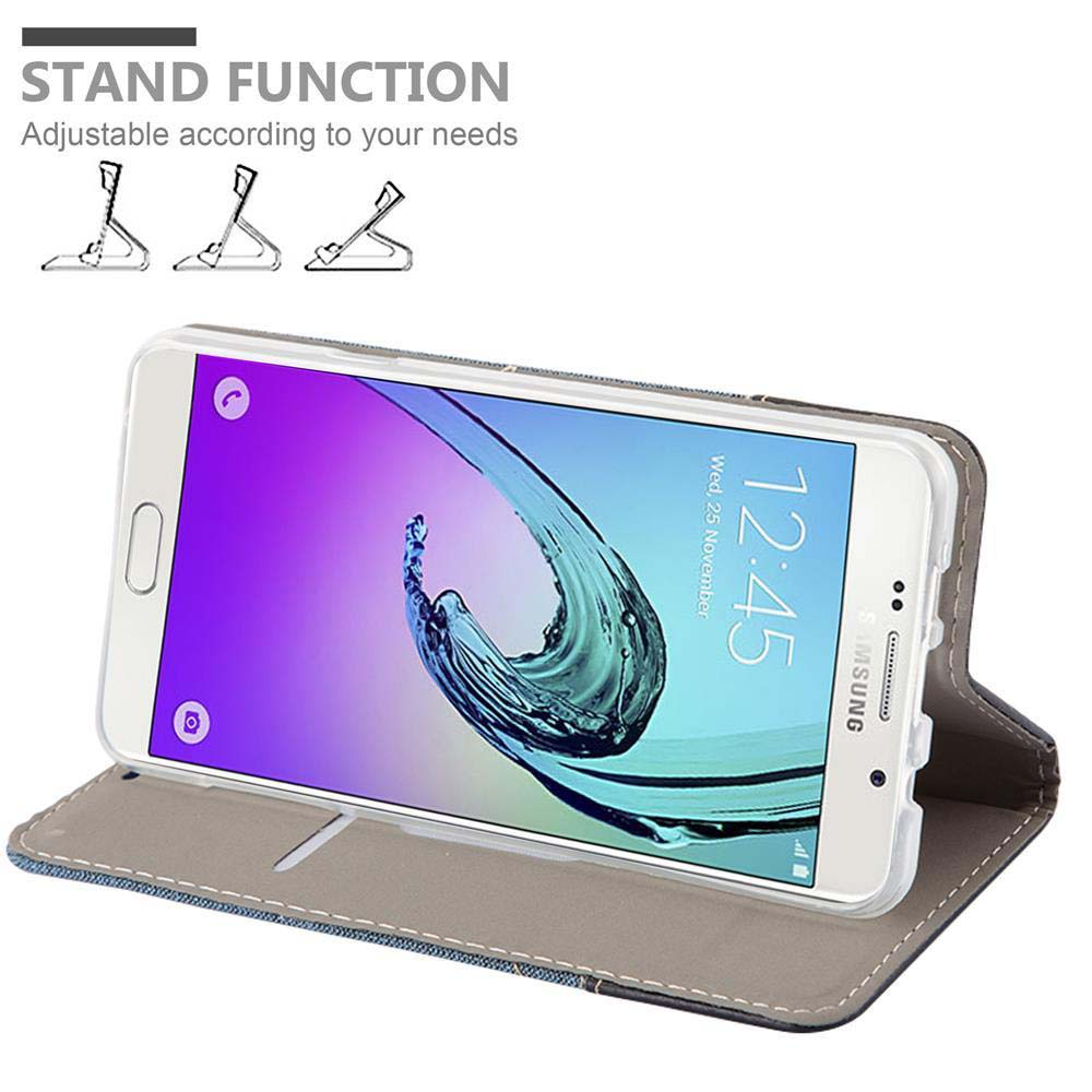 Ein weißes Telefon in einer Handyhülle in einem Ständer. Text: STAND FUNCTION.