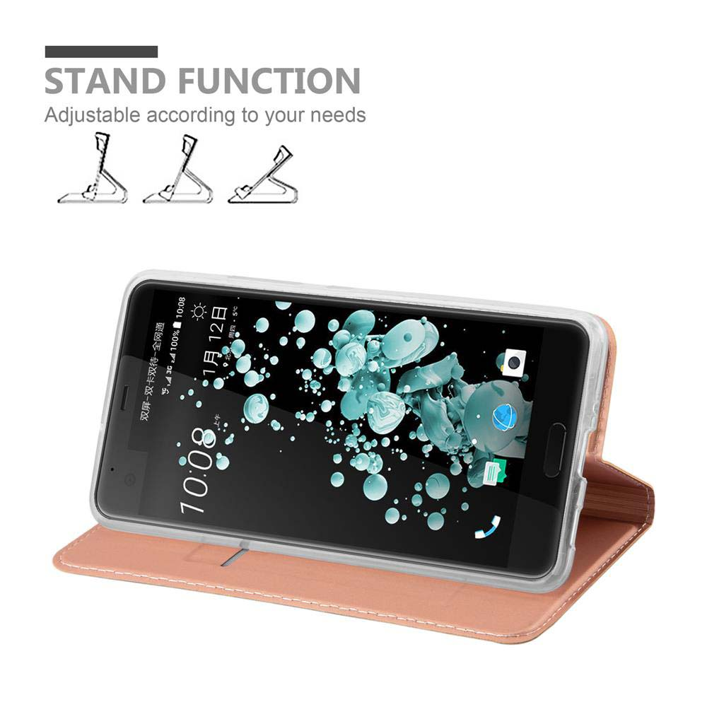 Telefono in custodia rosa con supporto. Mostra schermo con motivo bianco e blu, data e ora.