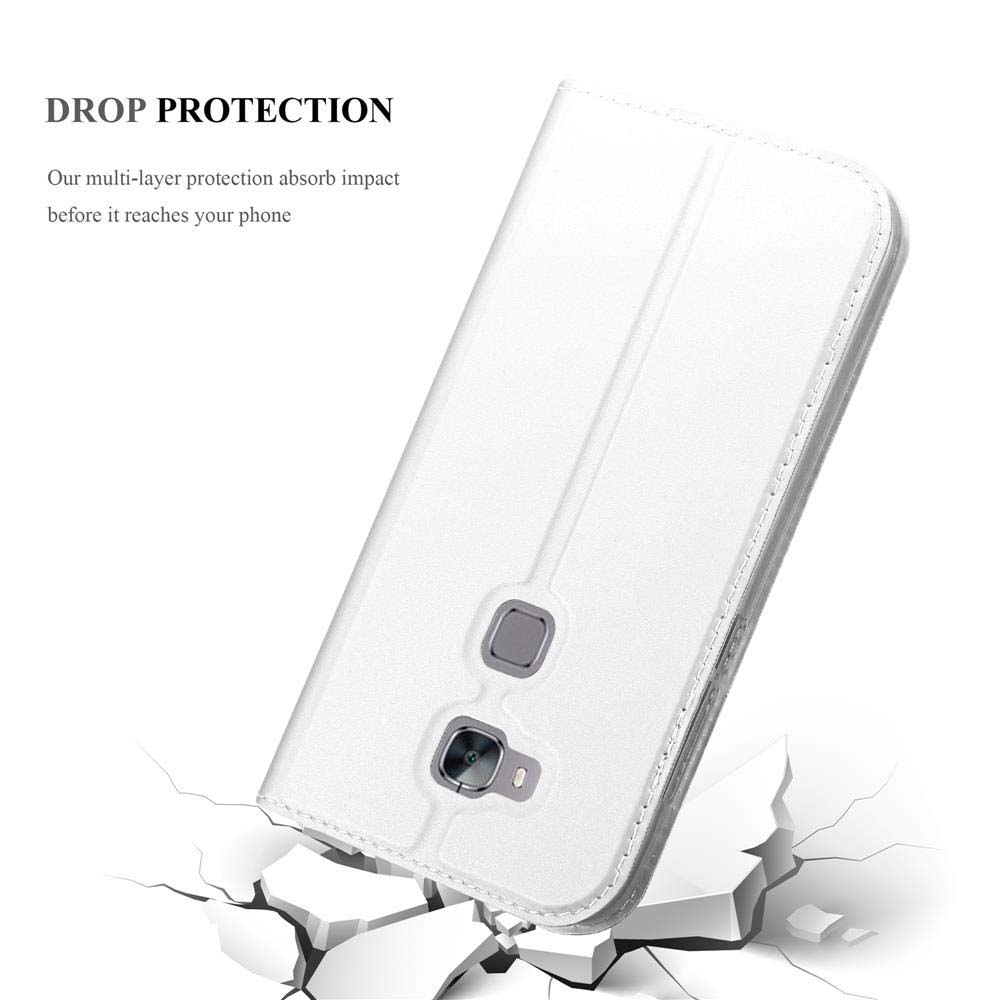 Funda blanca de teléfono abierta, mostrando el teléfono dentro. La funda está sobre una superficie agrietada, sugiriendo protección contra caídas.