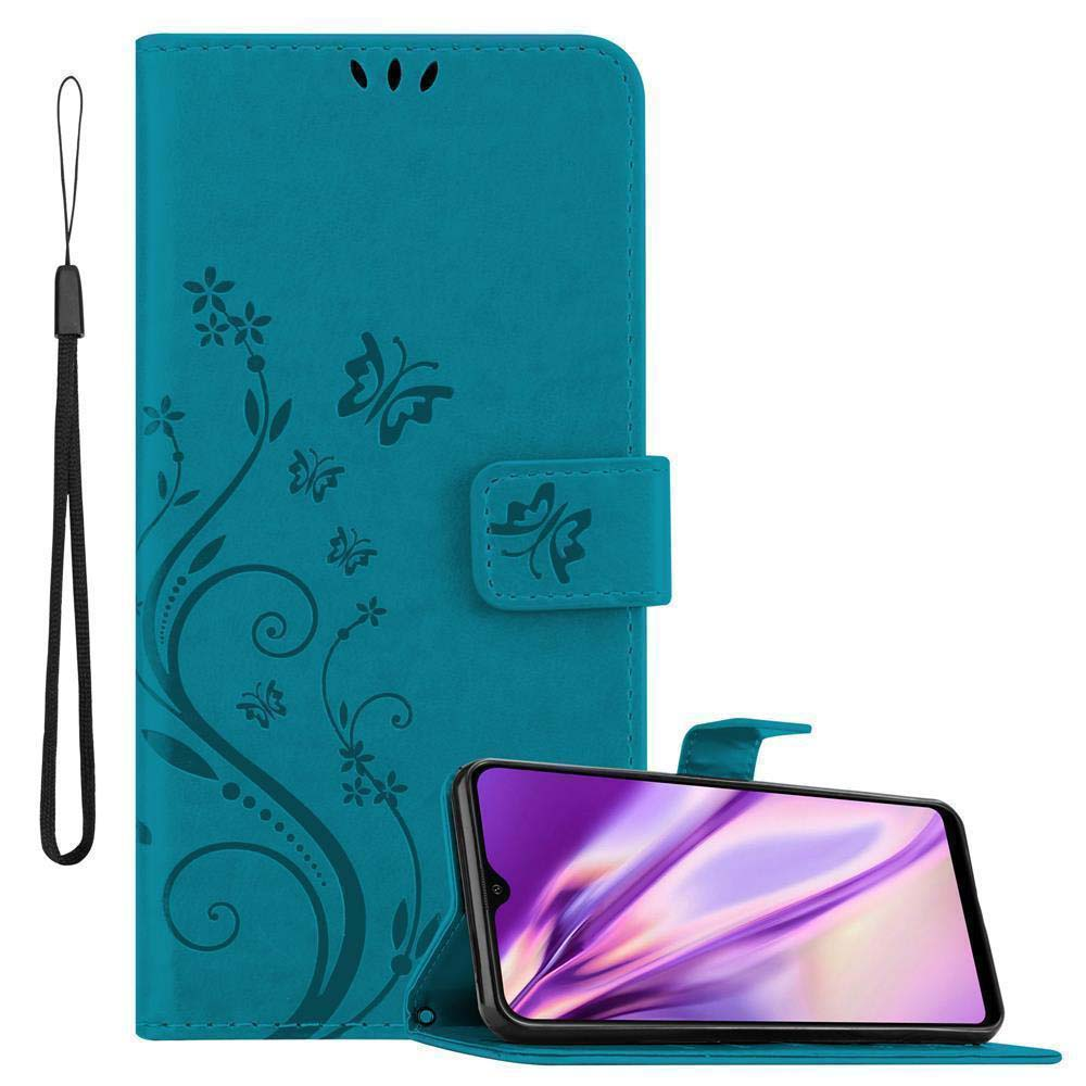 Custodia per telefono color teal con design floreale e farfalle, aperta, con cinturino nero. Telefono presente.