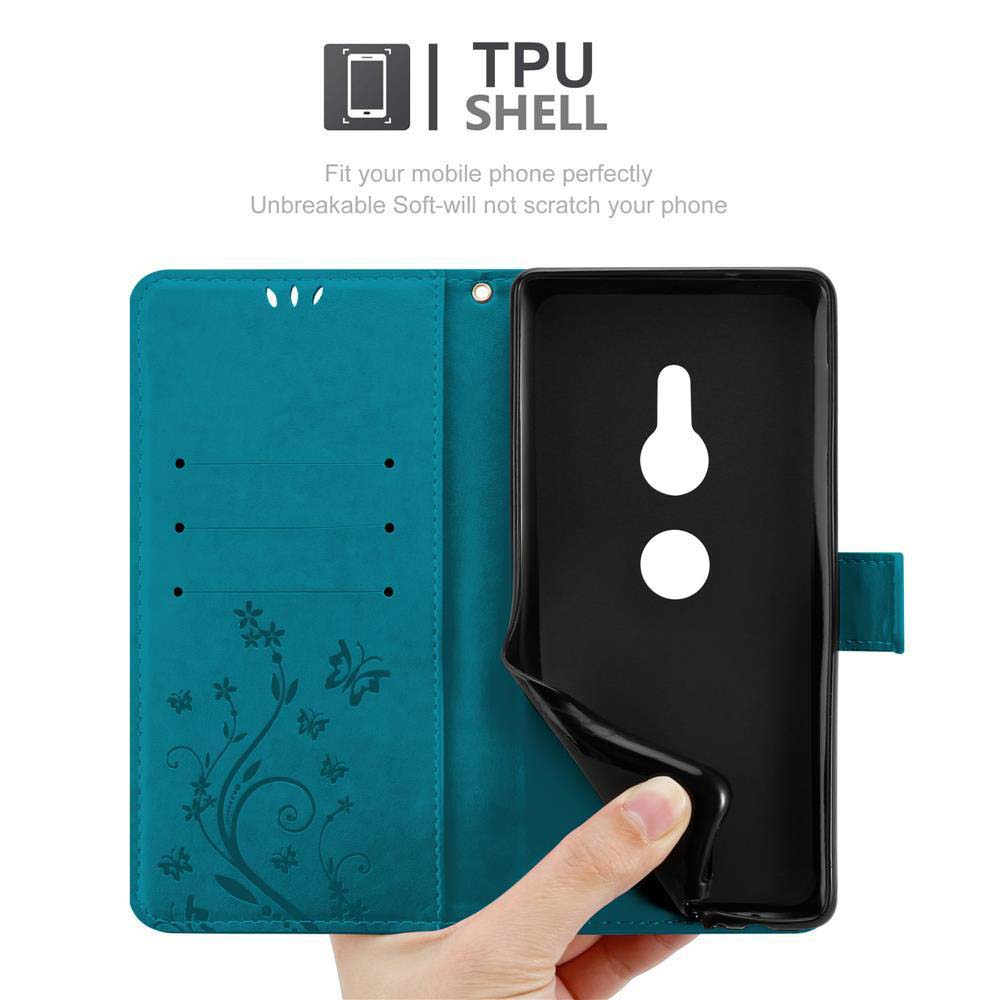 Una custodia turchese per telefono aperta. Il telefono è in una custodia nera, con design floreale.