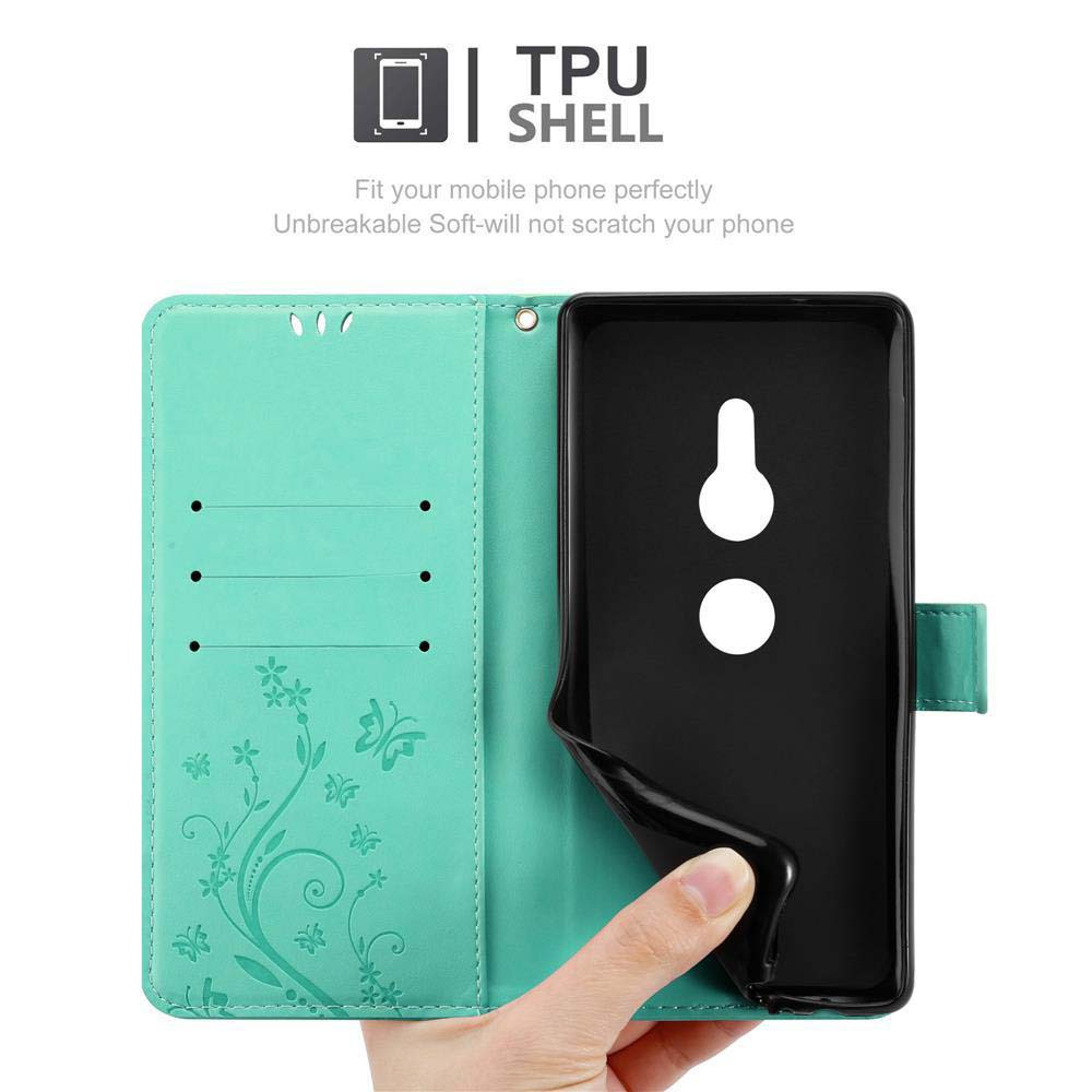 Custodia per telefono turchese, aperta. All'interno, un supporto per telefono nero. Mano che tiene la cover. Sfondo bianco.