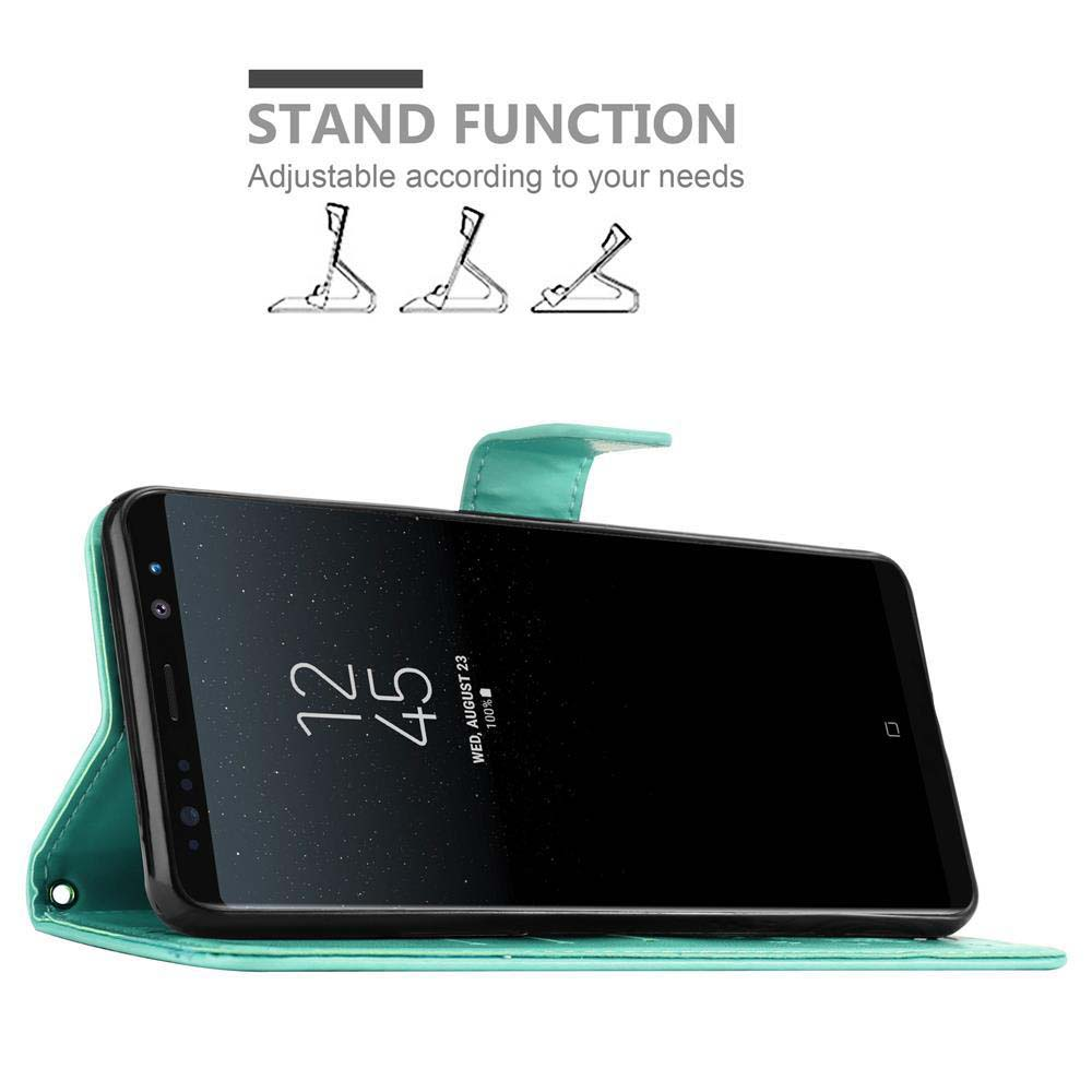 Un telefono in una custodia verde, lo schermo del telefono mostra l'ora. Viene mostrata la funzione stand.