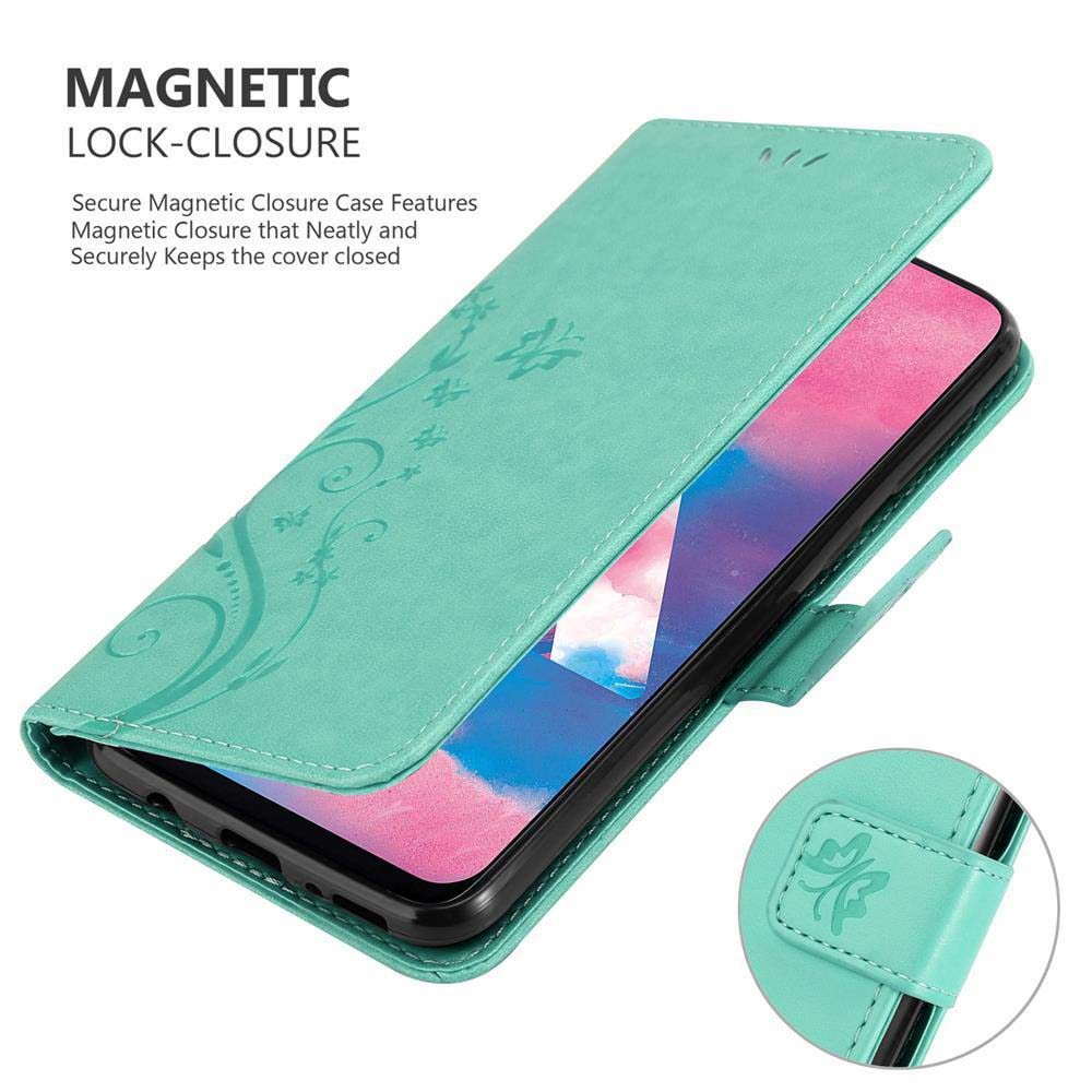 Custodia verde con design floreale. Il telefono è dentro e ha una chiusura.