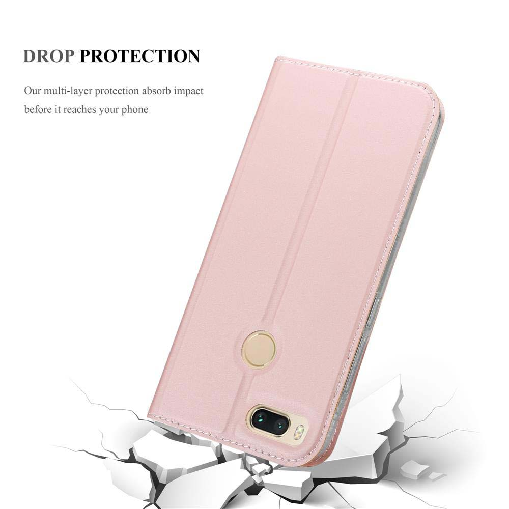 Custodia per telefono rosa su superficie incrinata. Testo: protezione dalle cadute.