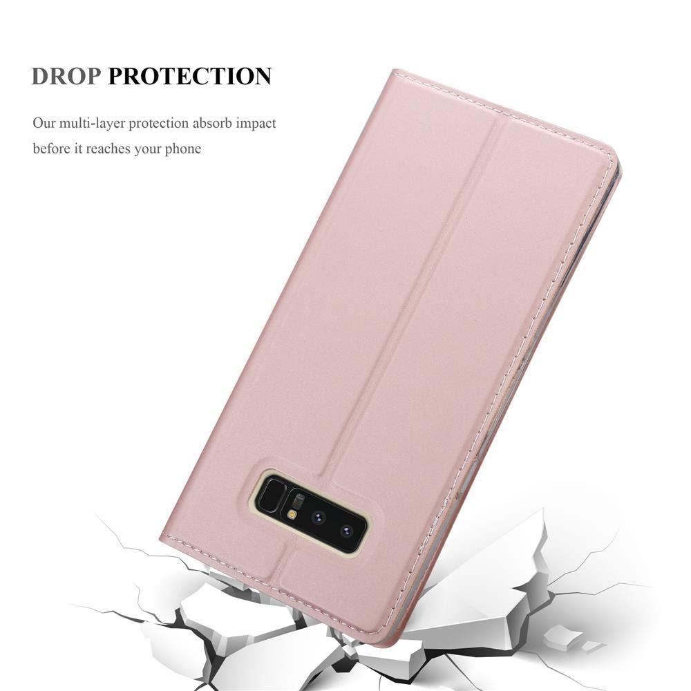 Eine rosa Handyhülle mit Telefon. Die Hülle liegt auf einer Oberfläche mit Rissen, was Sturzschutz suggeriert.