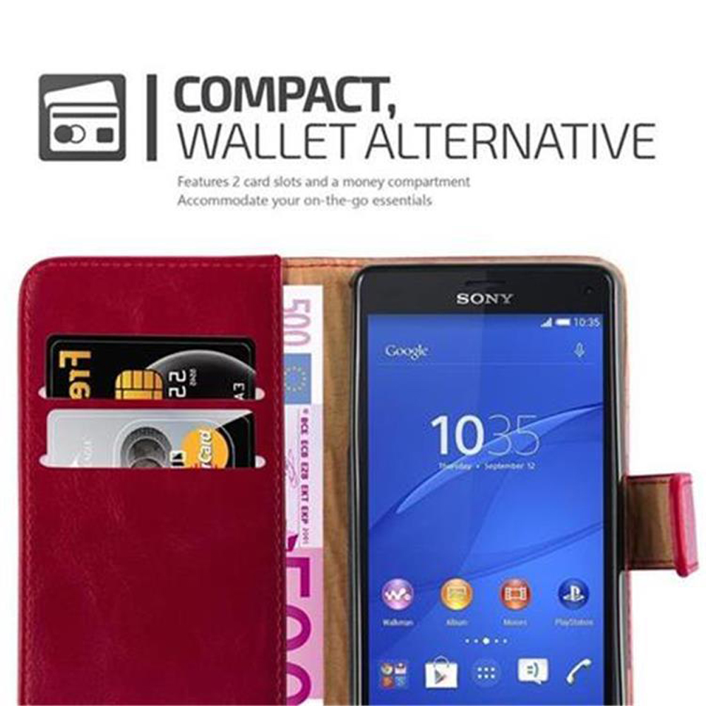 Telefono in una custodia a portafoglio rossa con carte di credito, sfondo bianco.