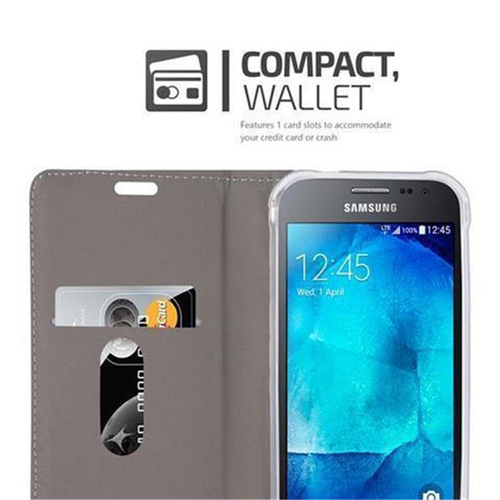 Custodia a portafoglio grigia, aperta, con fessura per carta di credito. Telefono visibile. Compatto, Portafoglio.