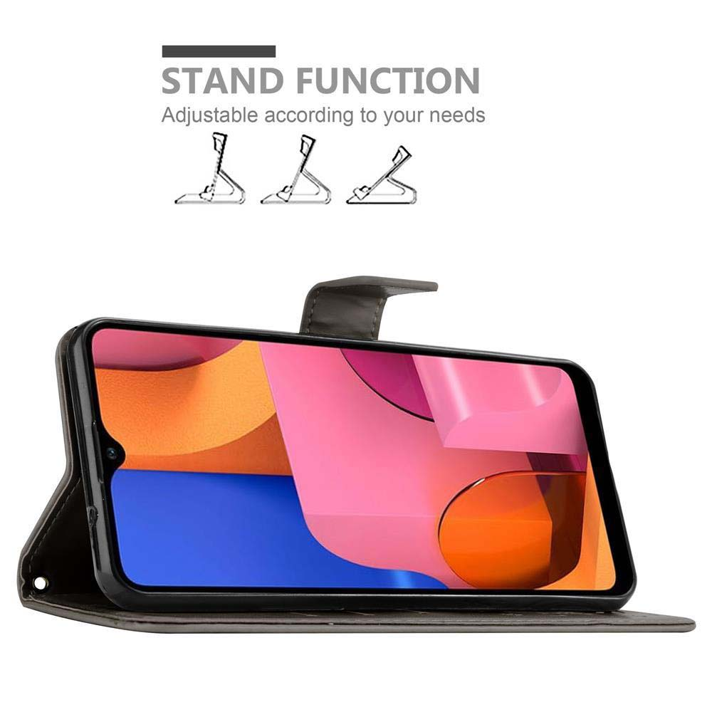 Un telefono in una custodia nera con supporto. Testo: STAND FUNCTION.