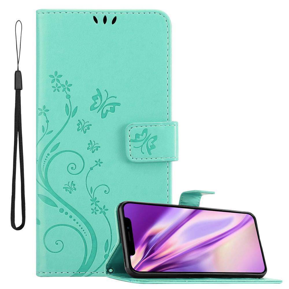 Eine türkisfarbene Handyhülle mit Riemen. Ein Telefon zeigt eine violette Oberfläche.