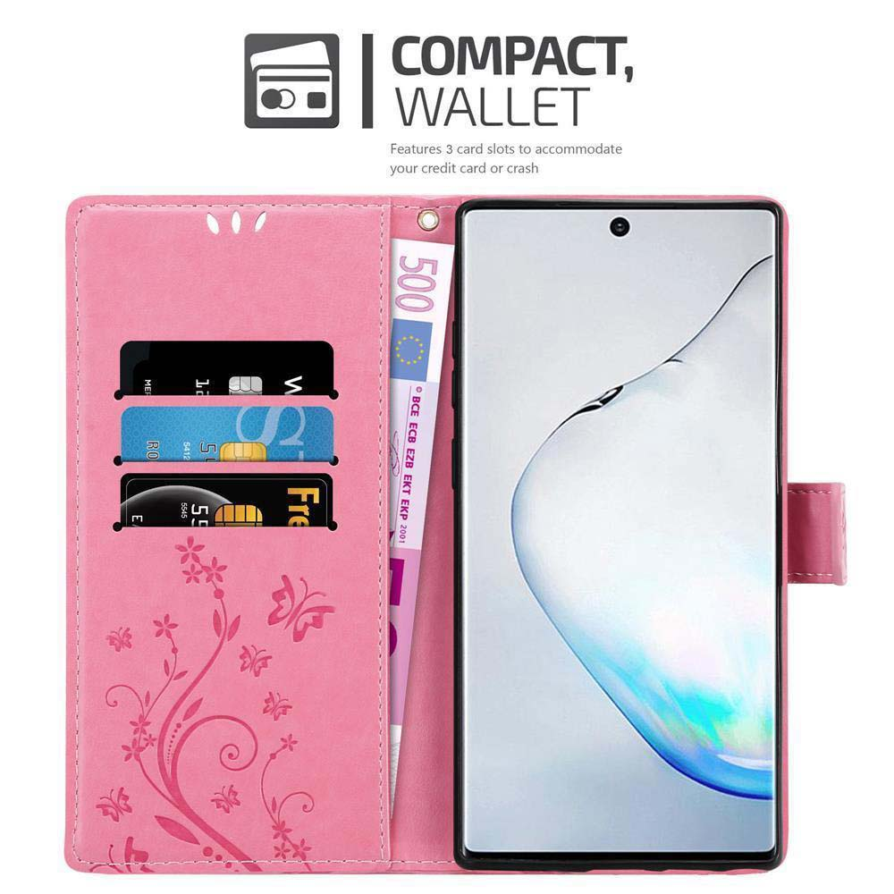 Custodia rosa con telefono. Interno mostra carte e banconota. Design floreale a sinistra.