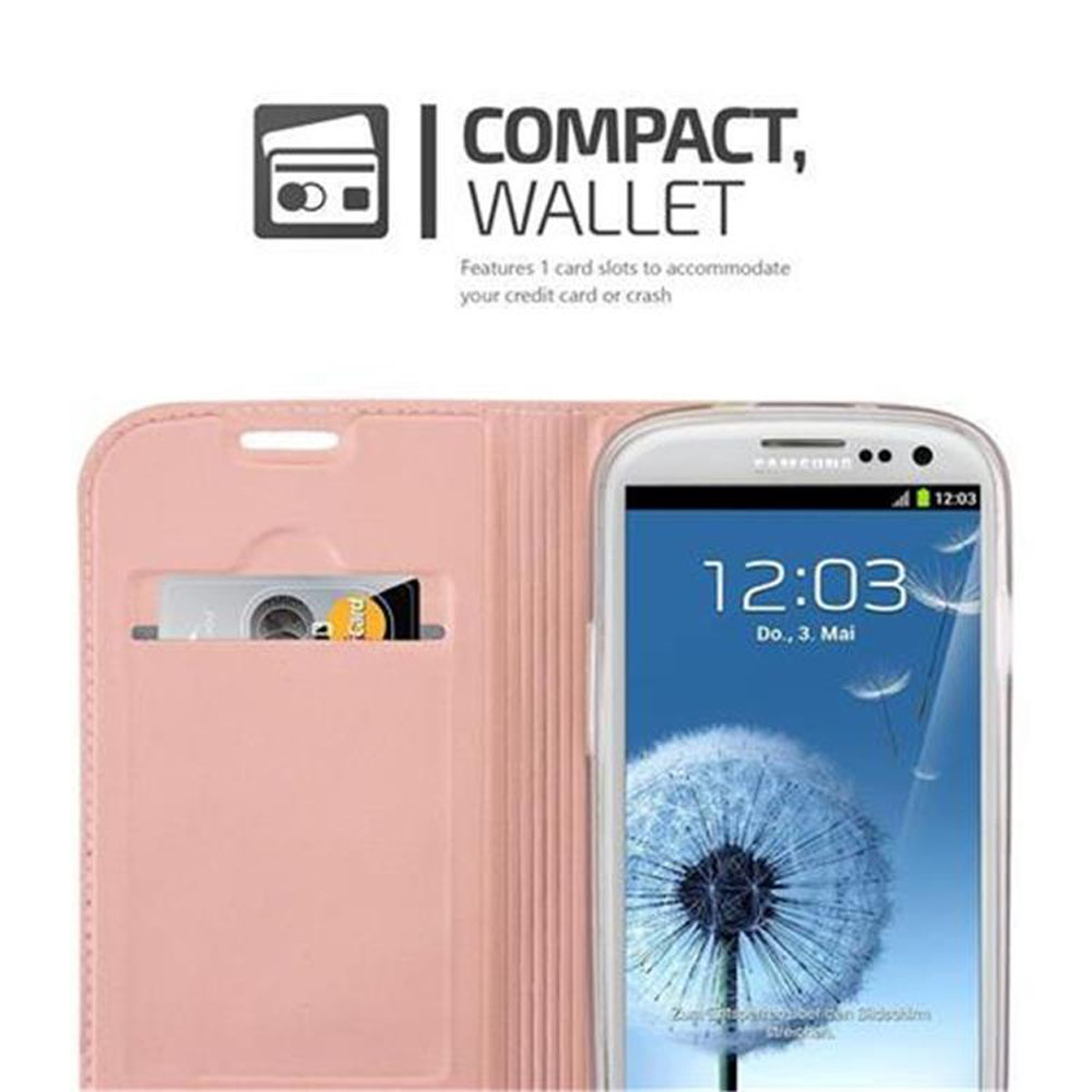 Custodia a portafoglio per telefono rosa aperta. Telefono a destra. Lo schermo mostra l'ora 12:03 e un dente di leone.