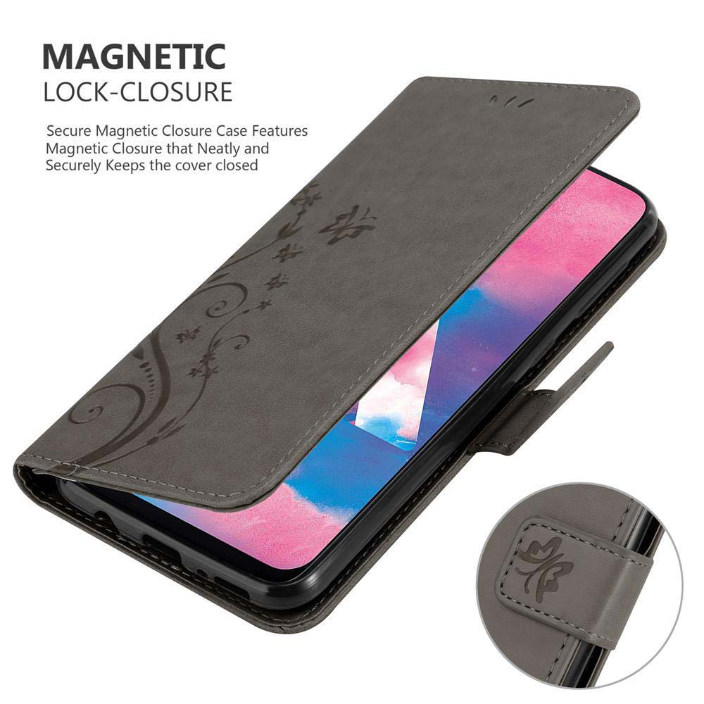 Custodia per telefono in pelle grigia, design floreale. Chiusura magnetica. Telefono con schermo rosa.