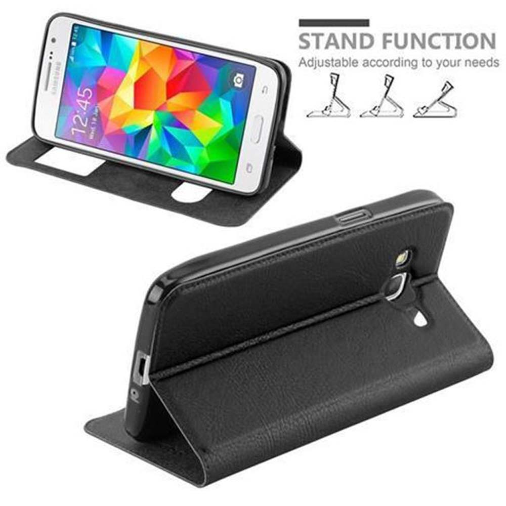 Un teléfono en una funda negra en un soporte. La pantalla muestra una imagen colorida. 