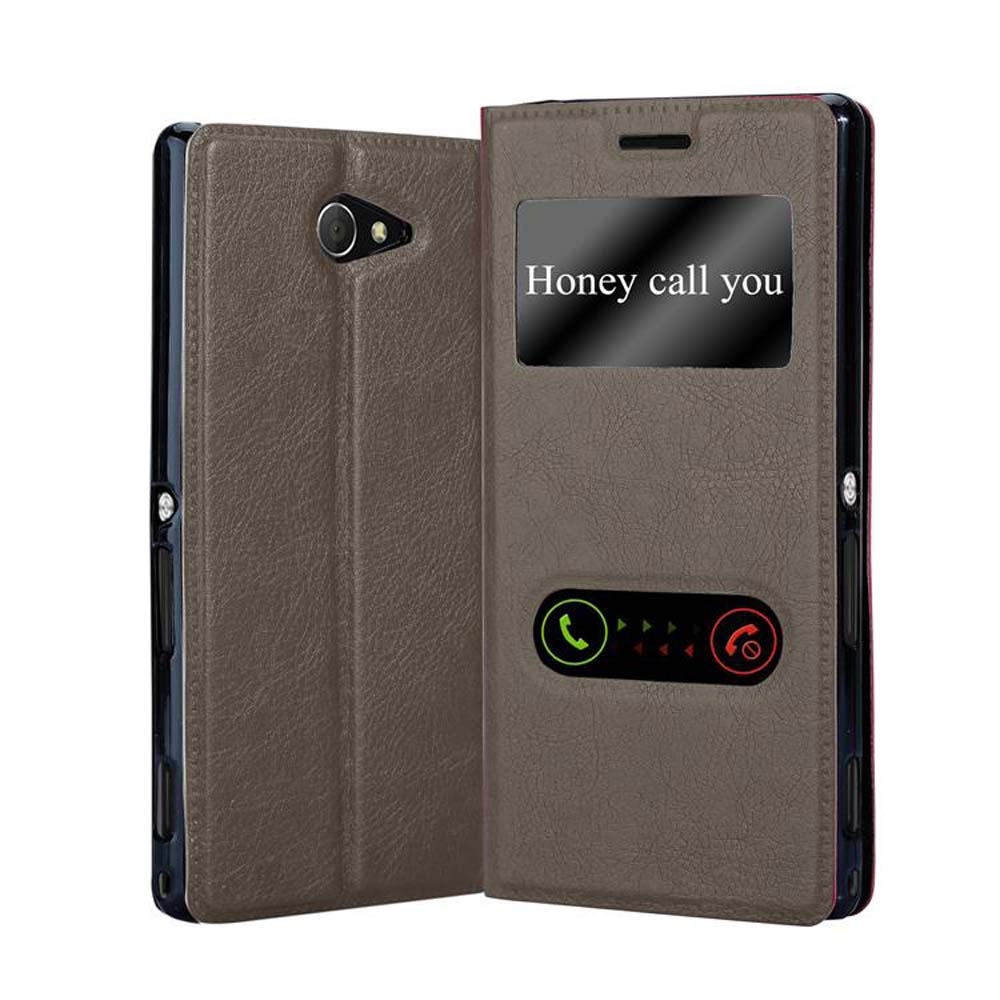 Funda de teléfono marrón con ventana. La pantalla muestra el texto: Honey call you.